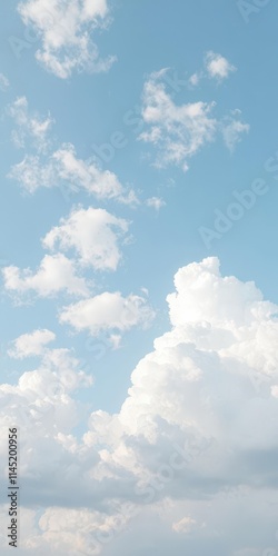 A pale blue sky dotted with fluffy white cumulus clouds, clean, aerial view