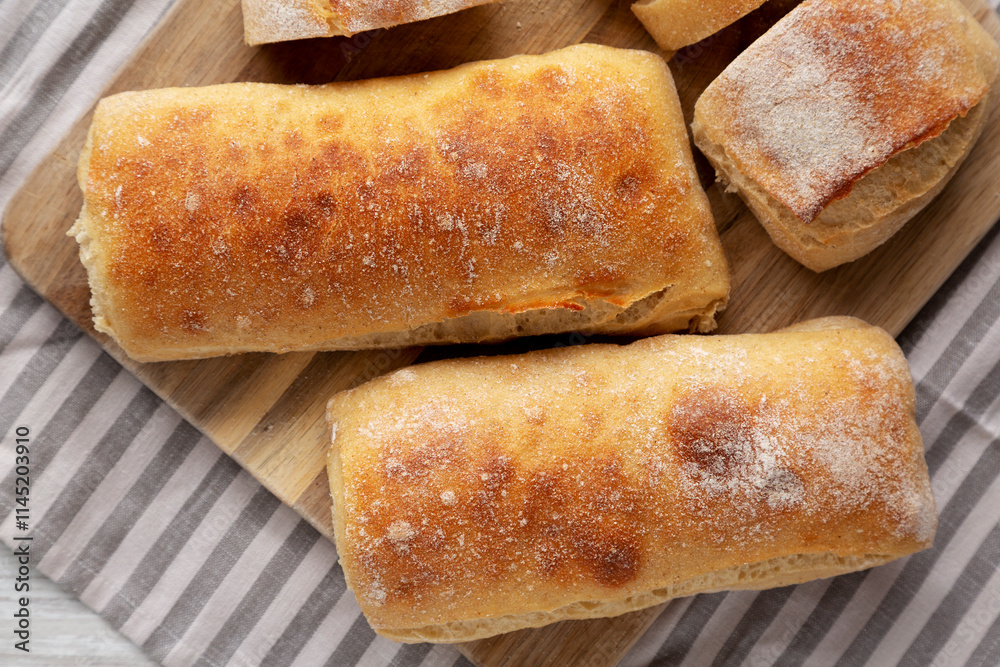 Homemade Sliced Ciabatta Bread on a wooden board, top view. Flat lay, overhead, from above.