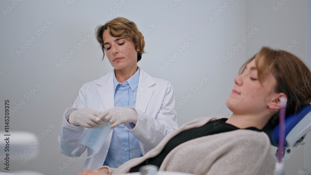 Obraz premium Woman sitting dental chair at treatment preparation closeup. Female dentist