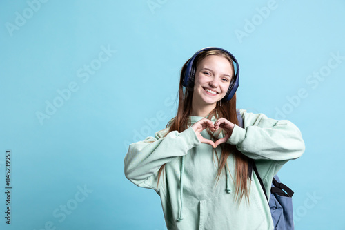 Photography Portrait of friendly smiling woman doing heart symbol shape gesture with hands, being affectionate