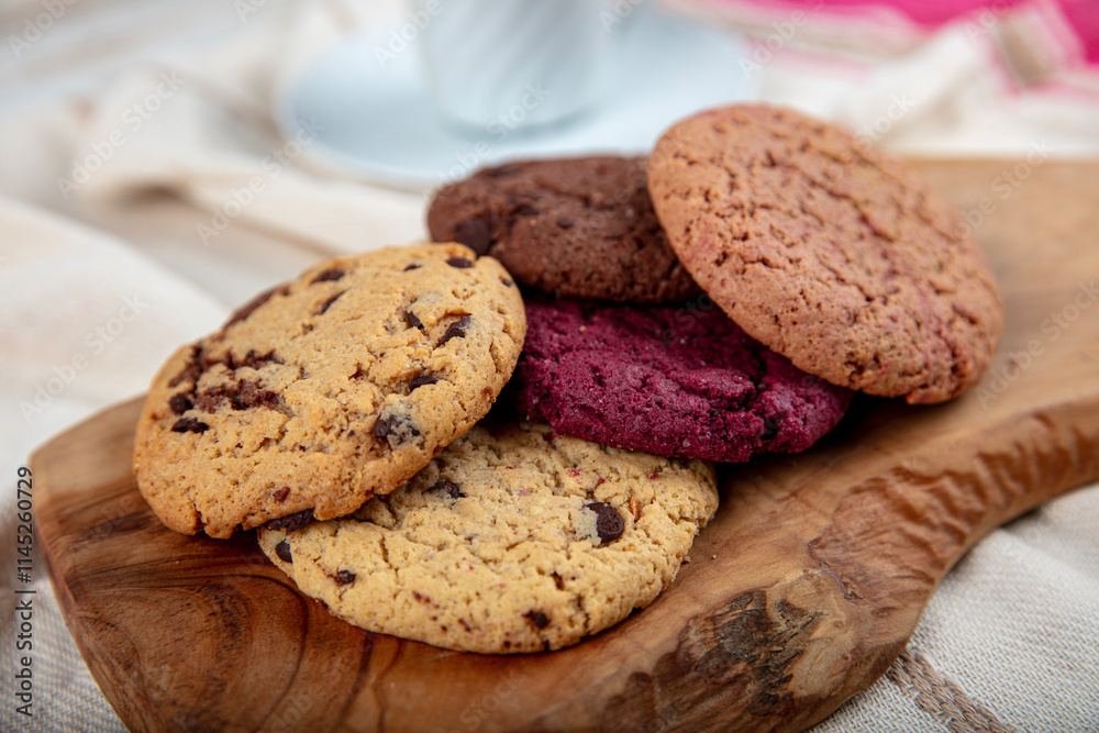 Cookie, Close-up of oatmeal cookies with raisins and chocolate on a plate in warm colors with a blurred background. Healthy Food Snack Concept. Cookie, Close-up of oatmeal cookies with raisins and chocolate on a plate in warm colors with a blurred background. Healthy Food Snack Concept.