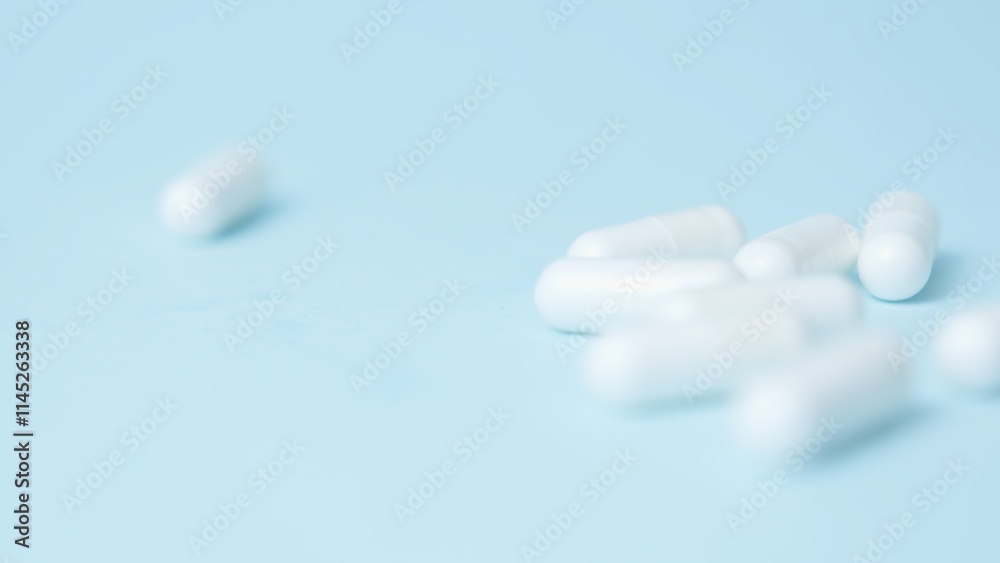A bunch of white pills tablets on light blue background,. High quality photo A bunch of white pills tablets on light blue background,. High quality photo