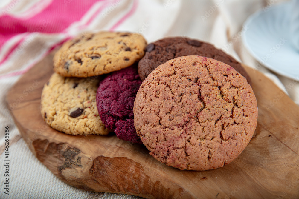 Cookie, Close-up of oatmeal cookies with raisins and chocolate on a plate in warm colors with a blurred background. Healthy Food Snack Concept. Cookie, Close-up of oatmeal cookies with raisins and chocolate on a plate in warm colors with a blurred background. Healthy Food Snack Concept.