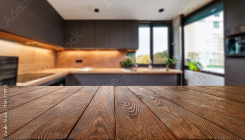 Empty wooden table in front of blurred modern kitchen interior background