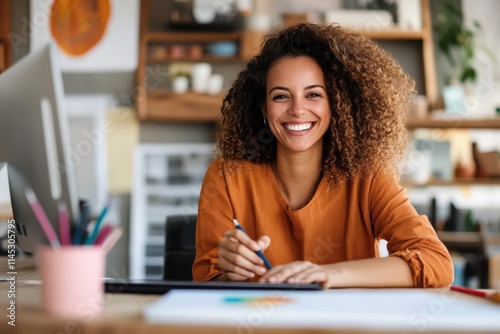 A young woman with a joyful expression works within a creatively decorated office space, showcasing the blend of modern art and lively ambience. photo