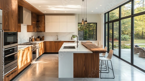 Wallpaper Mural Modern kitchen with wooden cabinetry and large windows overlooking nature. Torontodigital.ca