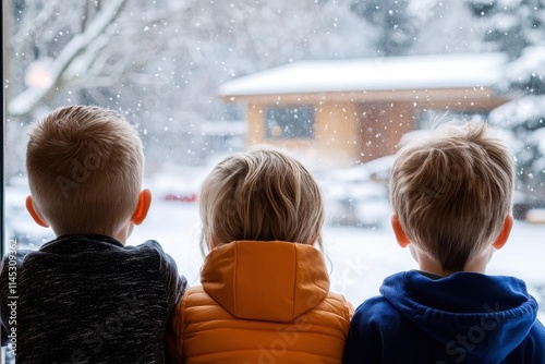 Three children, two in orange and yellow jackets, gaze out a window at a snowfall scenery, highlighting the innocence and wonder of childhood moments.