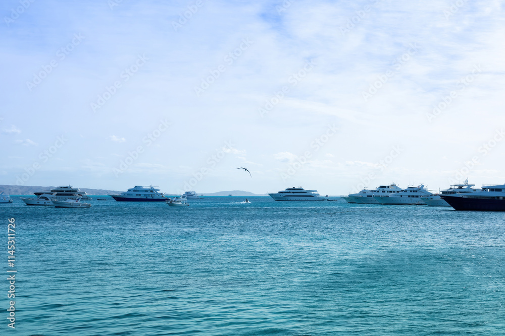 Serene seascape with boats on clear blue water under bright sky Serene seascape with boats on clear blue water under bright sky