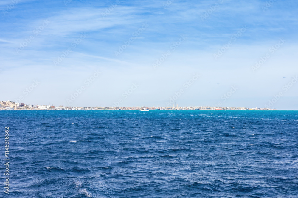 Fototapeta premium Expansive ocean horizon and clear blue sky capturing serenity and calm