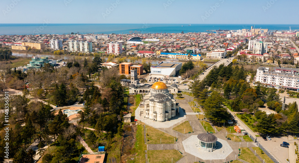 Fototapeta premium Aerial view of Poti Cathedral, river Rioni and city center on spring sunny day, Georgia