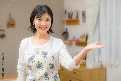 かわいい笑顔のお母さんの家事代行などのイメージ　カメラ目線のオススメやコチラの案内ポーズ