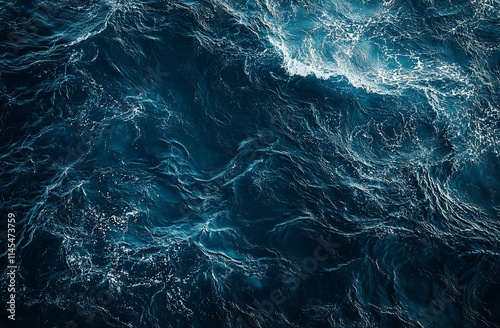 Aerial view of dark blue ocean waves with whitecaps.