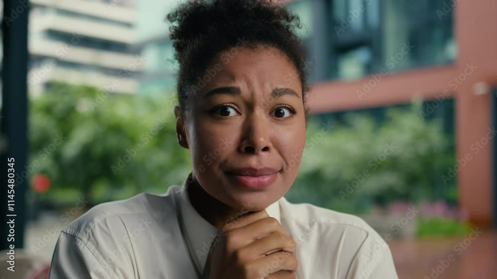 African American woman nervous biting lips female girl businesswoman business city outside bad problem financial trouble emotions face frustrated difficult job worker bankruptcy employer entrepreneur