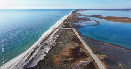 Southampton, NY, USA - 11-20-2024:  Late morning aerial, drone, video of Panquogue Beach on a sunny fall day.  50 FPS