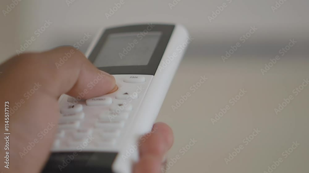 Close up of woman hand holding air condition remote. Close up of woman hand holding air condition remote.