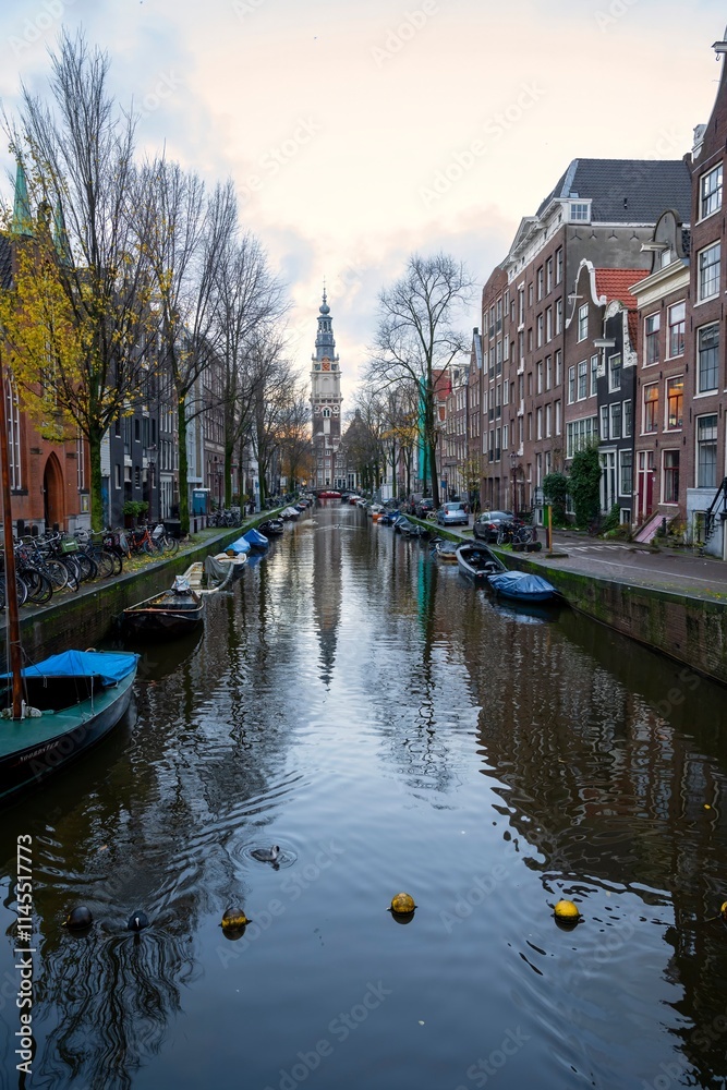 Naklejka premium Cityscapes of Amsterdam with boats moored along the canal with Zuiderkerk (Southern Church) view