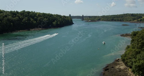 wide shot looking up the Menai Strait to Britannia Bridge with speed boats photo