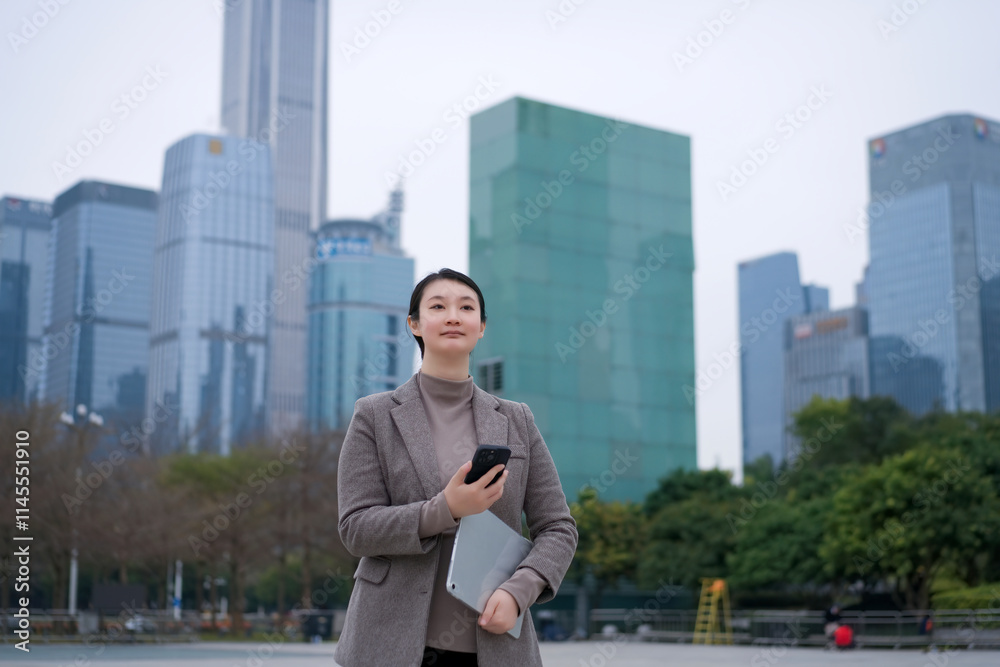Confident Businesswoman in a Modern Urban Landscape with Technology Confident Businesswoman in a Modern Urban Landscape with Technology