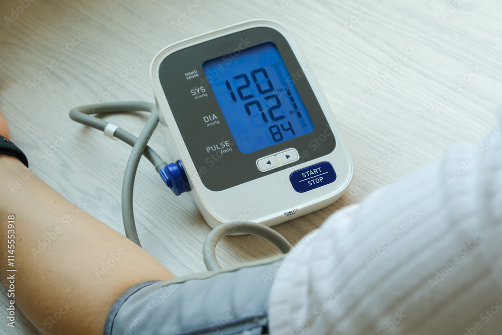 Man check blood pressure monitor and heart rate monitor with digital pressure gauge. Health care and Medical concept	