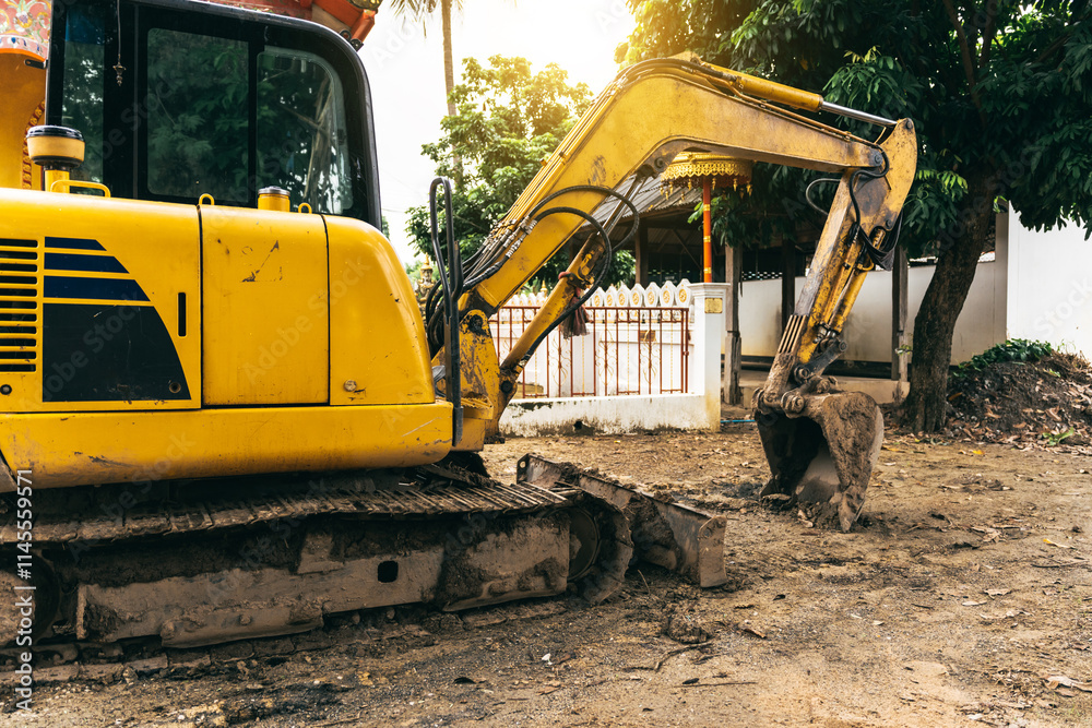 A yellow excavator focuses on its metal bucket teeth,digging soil at a construction site.This earth-moving machinery,including loaders and backhoes,is essential for excavation and earthwork projects A yellow excavator focuses on its metal bucket teeth,digging soil at a construction site.This earth-moving machinery,including loaders and backhoes,is essential for excavation and earthwork projects
