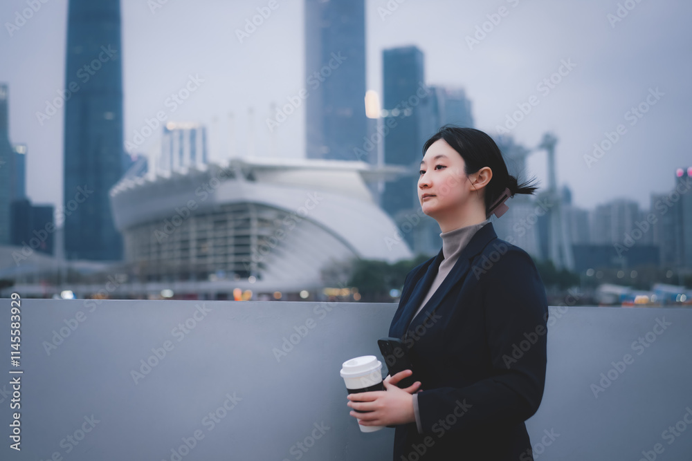 Ambitious Businesswoman Overlooking a Modern City Skyline Ambitious Businesswoman Overlooking a Modern City Skyline