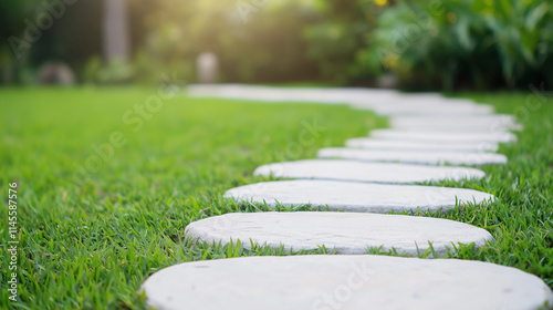 Stone Pathway Leading Through Lush Green Grass:  A winding path of smooth, round stones leads through a vibrant green lawn, bathed in soft, golden sunlight. photo