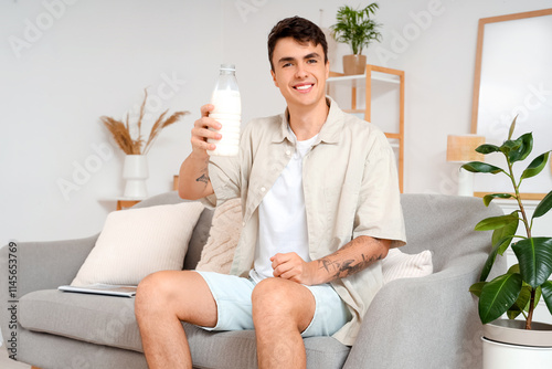 Young man with bottle of mi...