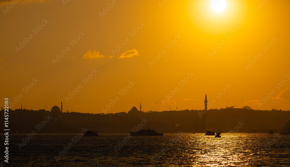 Eminonu city with mosque silhouettes in the background at sunset