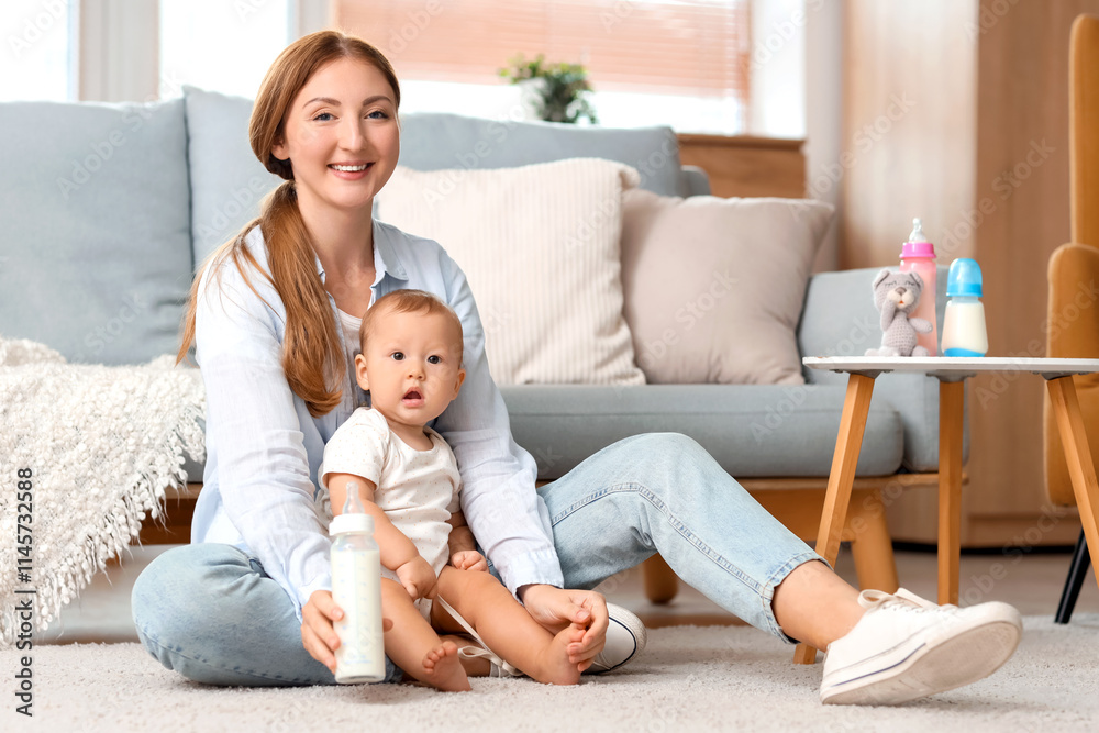 Mother with bottle of milk and her baby sitting on floor at home Mother with bottle of milk and her baby sitting on floor at home