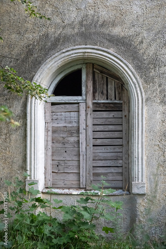 Closed window of an abandoned house.