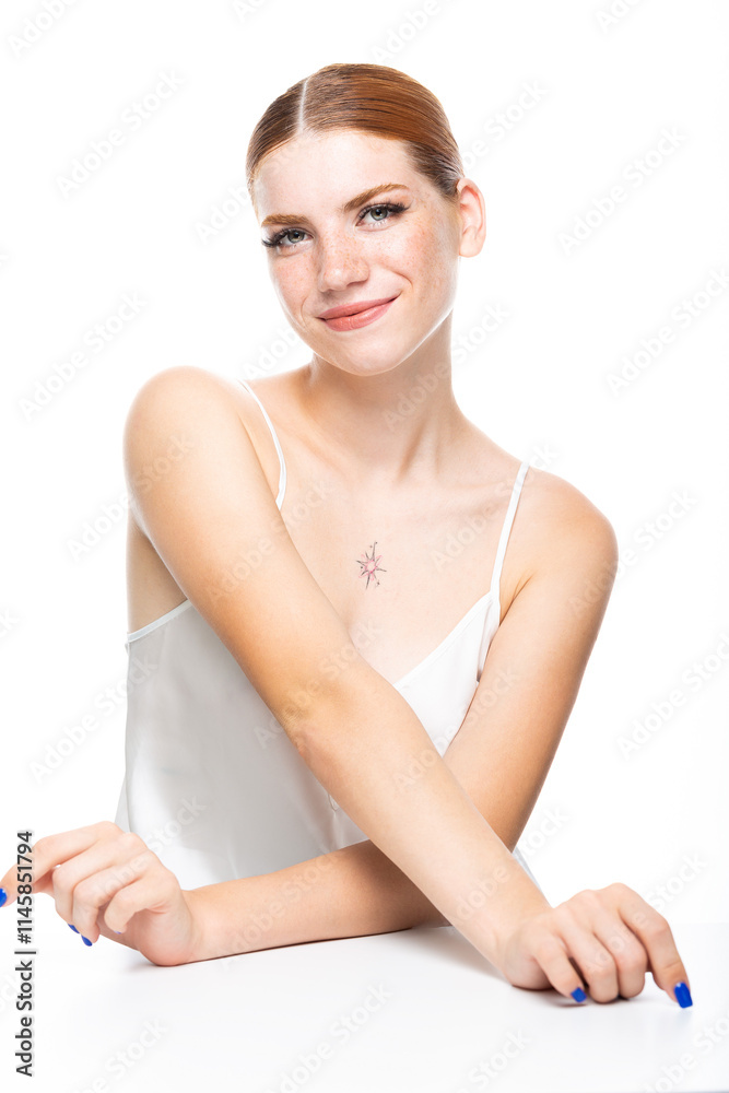 A young girl with red hair with freckles in a white top. Beauty portrait of a woman on a white background in the studio. A young girl with red hair with freckles in a white top. Beauty portrait of a woman on a white background in the studio.