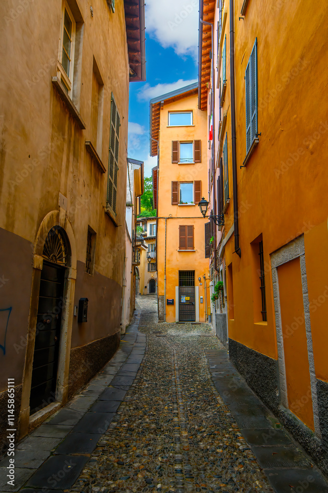 Fototapeta premium Brescia, Italy. Traditional colorful building with balconies, shutter windows and multicolored walls in typical italian street