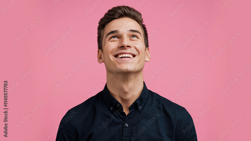 Obraz premium Man with Joyful Expression Looking Upwards in Black Shirt, Against a Solid Pink Background, Conveying Satisfaction and Happiness, Capturing Positive Emotions in a Minimalist Setting
