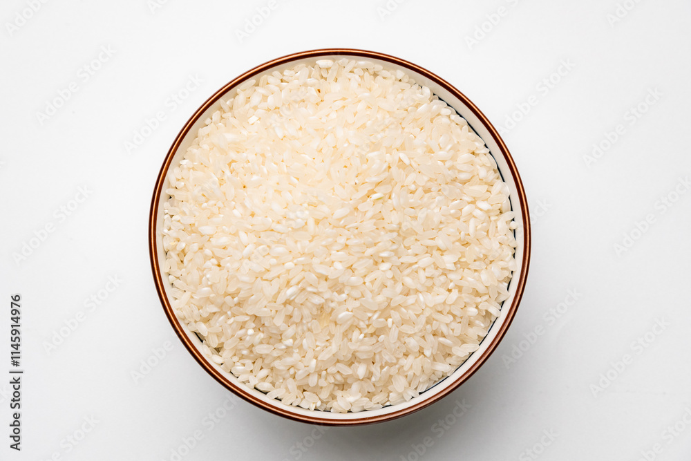 A bowl of raw white rice with a shadow, isolated on white background A bowl of raw white rice with a shadow, isolated on white background