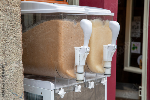 Distributeurs à granité remplies de glace pilée au parfum coca et au parfum pomme. Vente dans la rue. France photo