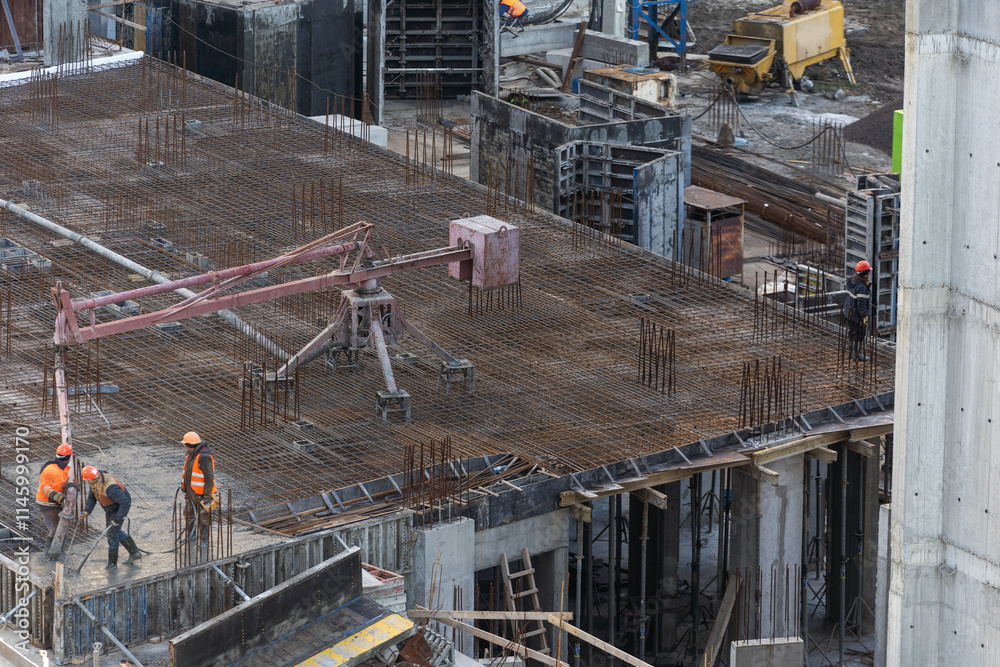 Naklejka premium Construction workers fabricating steel reinforcement bar at the construction site
