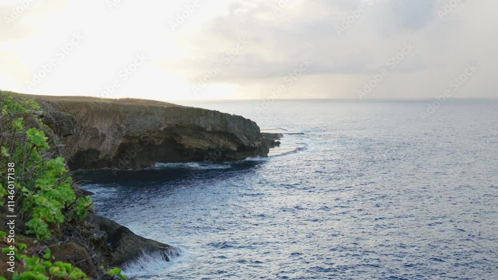 Waves crashing at Banzai Cliff during a bright afternoon - Saipan, Northern Mariana Islands, USA Waves crashing at Banzai Cliff during a bright afternoon - Saipan, Northern Mariana Islands, USA