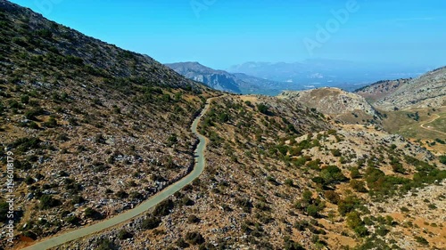 Mountain road winding through rugged terrain, Anogia, Greece, tranquil scene photo