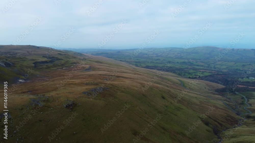 Wide Retreating Aerial View of Farmland Landscape on Brecon Beacons National Park Wales Landscape with Blue Haze on Horizon and Old Limestone Mining Quarry 4K Wide Retreating Aerial View of Farmland Landscape on Brecon Beacons National Park Wales Landscape with Blue Haze on Horizon and Old Limestone Mining Quarry 4K