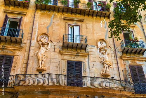 Palermo, Sicily, Italy. Watercolor illustration. Facade of an ancient house with sculptures and balconies on Via Lungarini. Sunny summer day photo