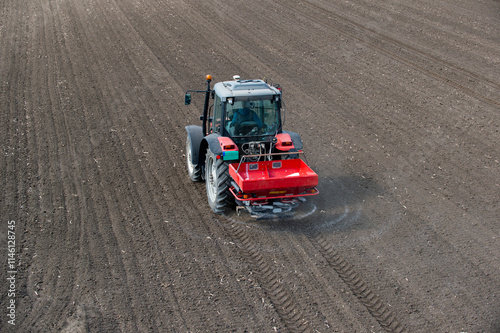 Tractor spreading artificial fertilizers