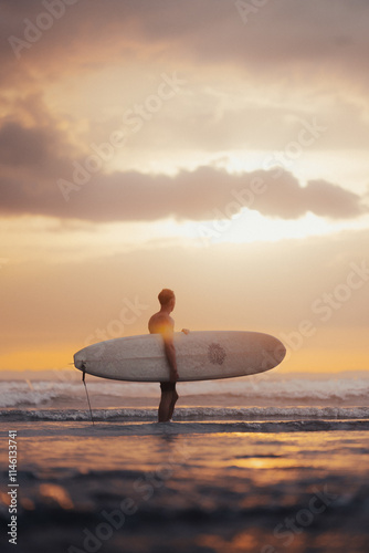 person going to surf during sunset