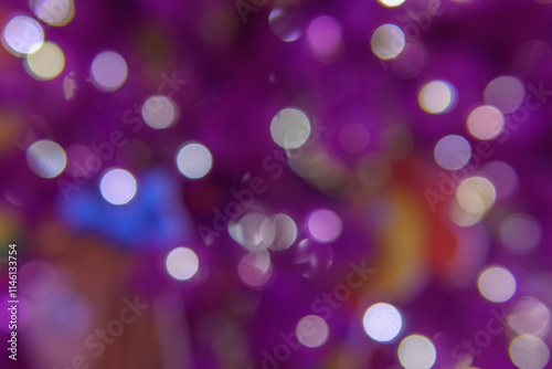 Chaotically placed bokeh circles shine with festive lights. Festive Christmas background.