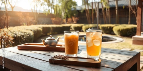 Refreshing drinks on a wooden table in a serene garden during golden hour