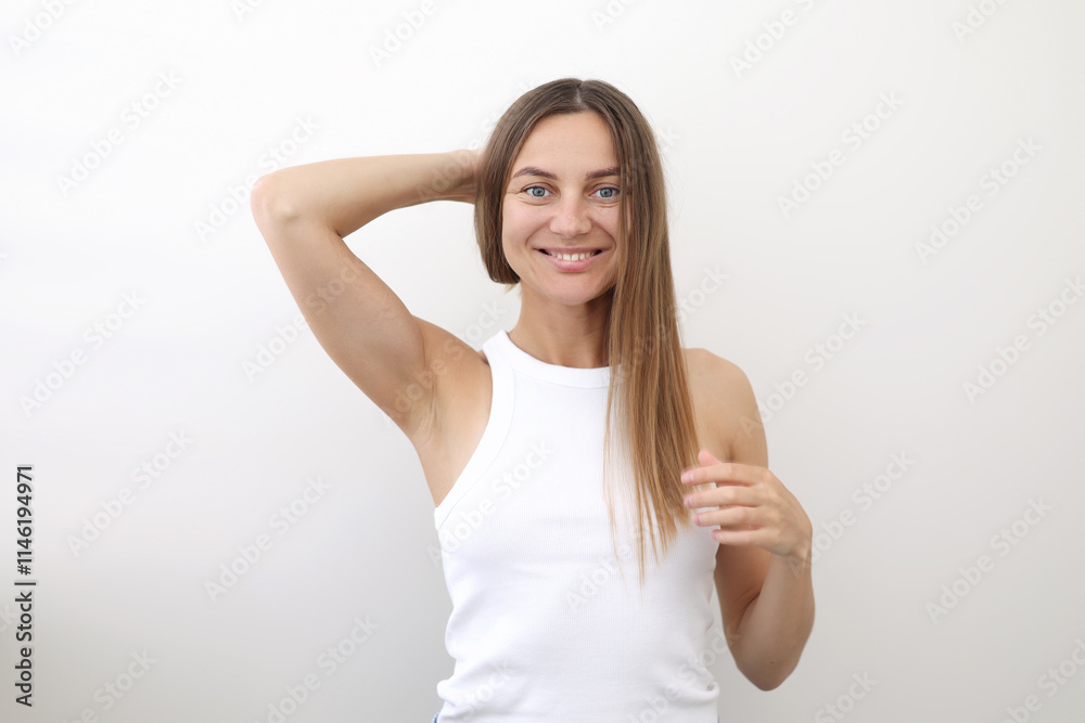 Portrait of naturally beauty positive young woman with long hair, wears casual home clothes, white top and blue shorts, looks at camera isolated over white background. Healthy lifestyle concept Portrait of naturally beauty positive young woman with long hair, wears casual home clothes, white top and blue shorts, looks at camera isolated over white background. Healthy lifestyle concept