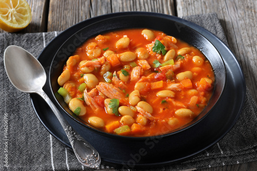 Pasulj, white bean soup with chicken in bowl photo