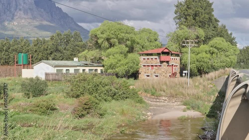 Anglo-Boer War blockhouse near Wolseley surrounded by lush greenery and mountain views photo