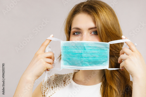 Female using protective face mask. photo