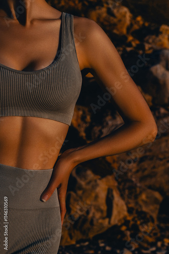Young slender woman's abs and breasts closeup