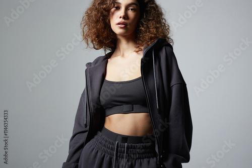 fashionable beautiful young woman in tracksuit of hoodie and trousers photo